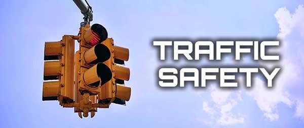traffic signal hanging with blue sky and clouds