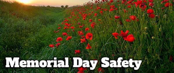 green field with red poppy flowers and words Memorial Day Safety in white